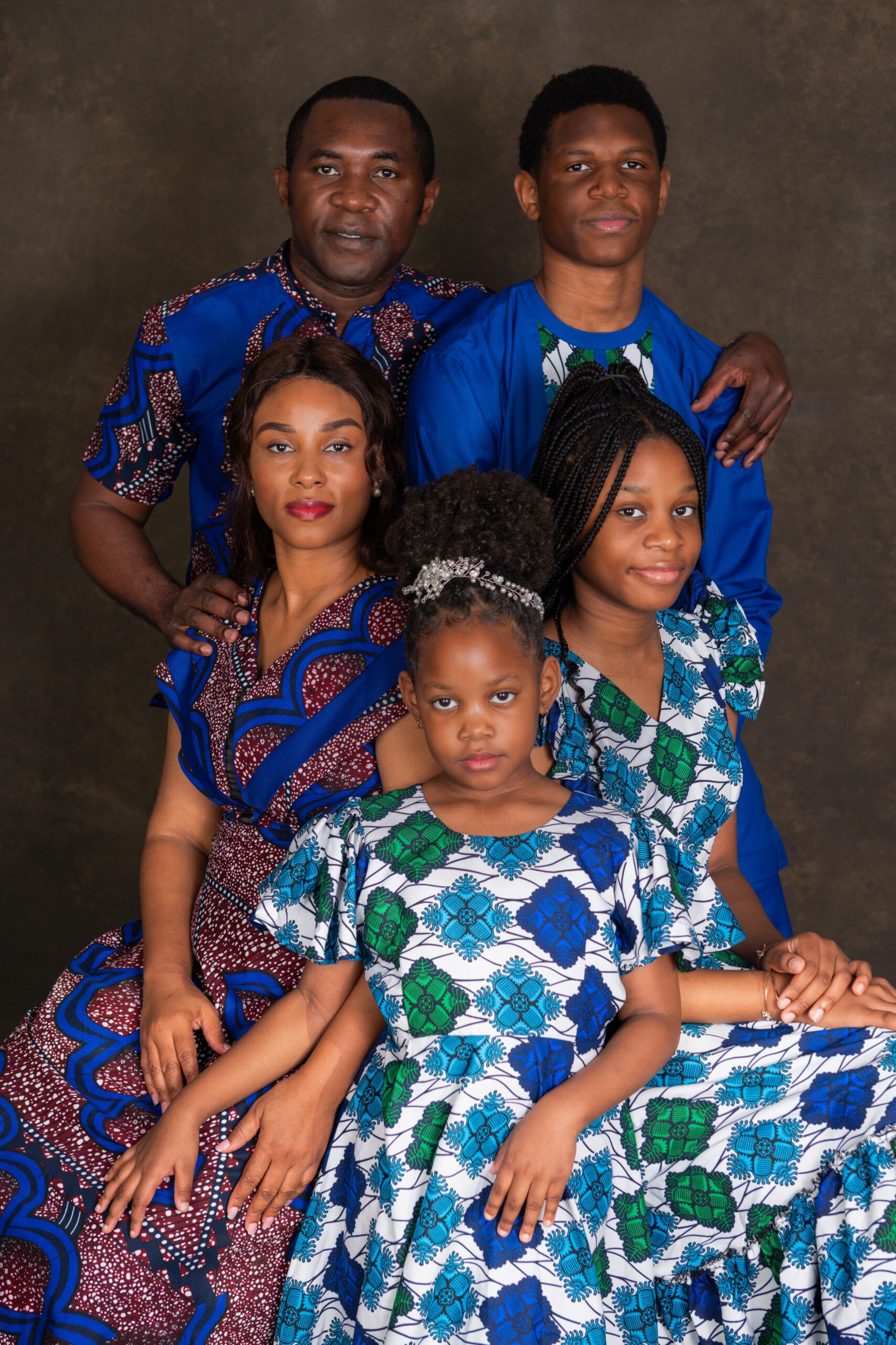 Family of five in coordinated patterned outfits, Dallas–Fort Worth studio portrait