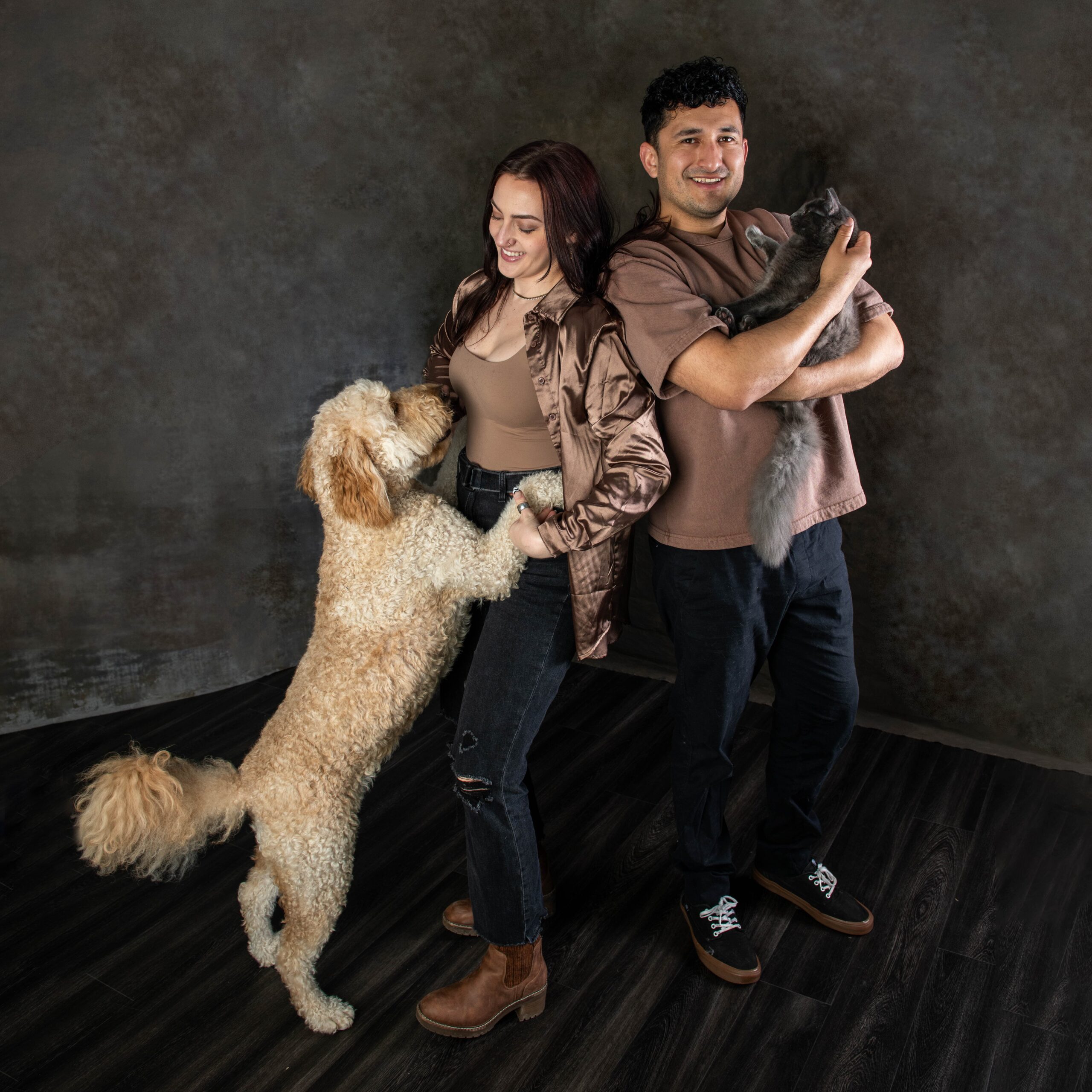 Couple with their dog and cat during a studio pet portrait session