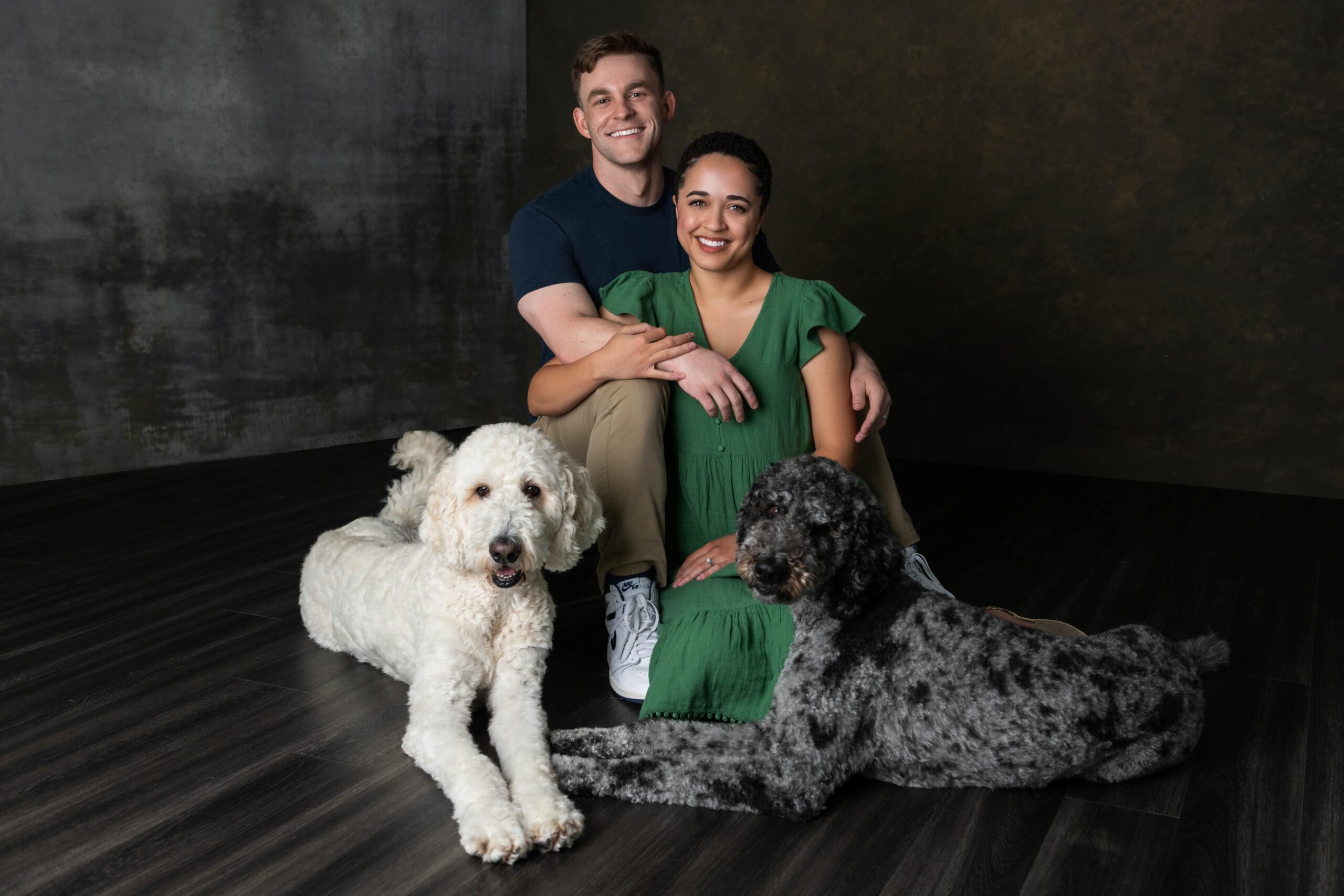 Couple with their two doodles during a Plano studio pet session