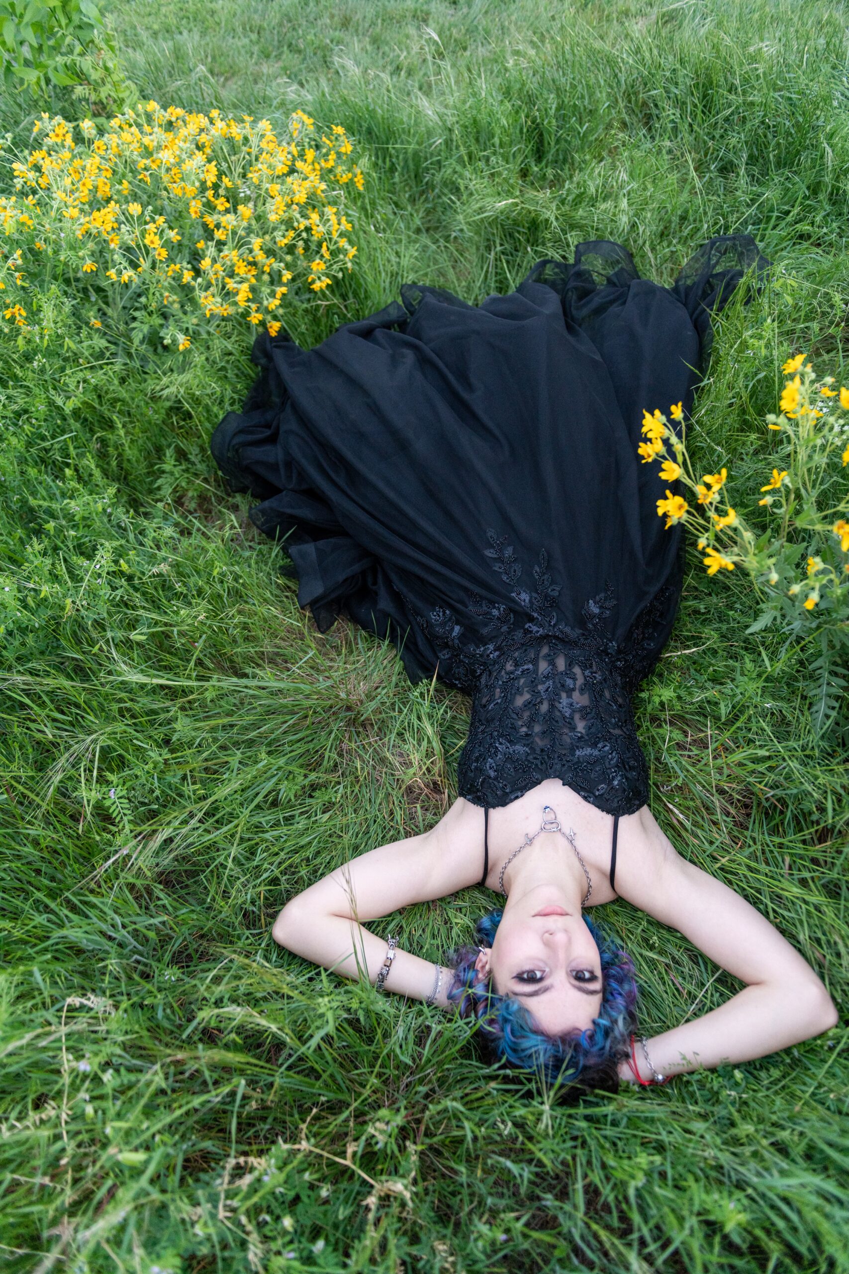 Senior portrait outdoors among spring wildflowers